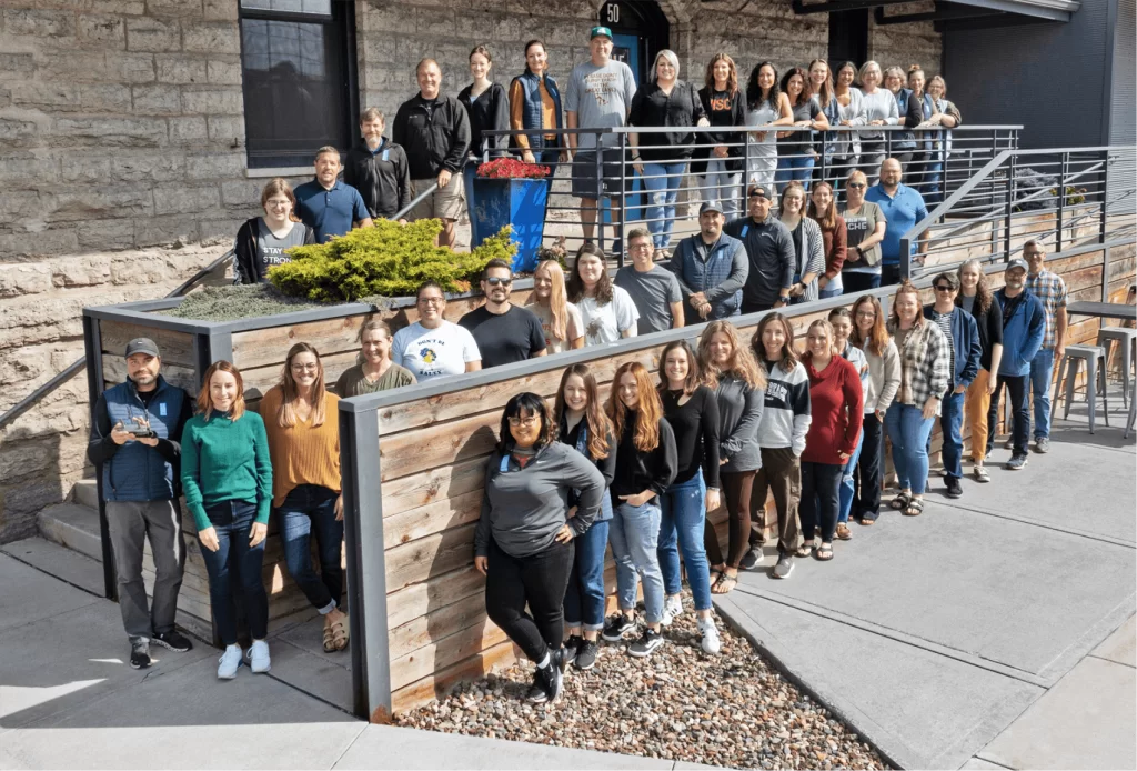 the entire Blue Door Consulting team standing outside our office building in Oshkosh, WI