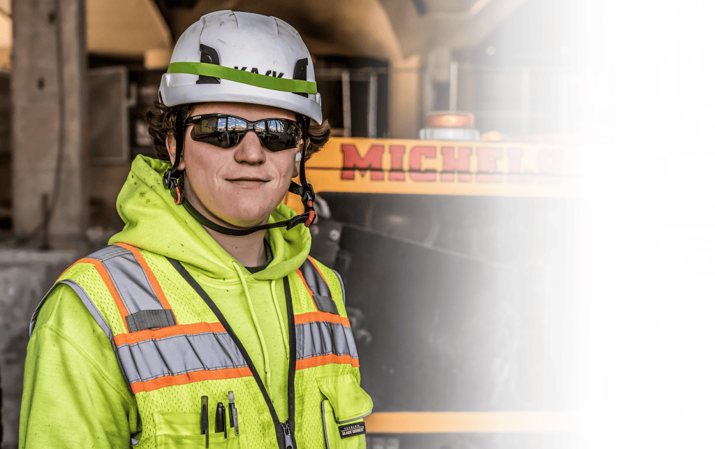 construction worker posing in front of machine